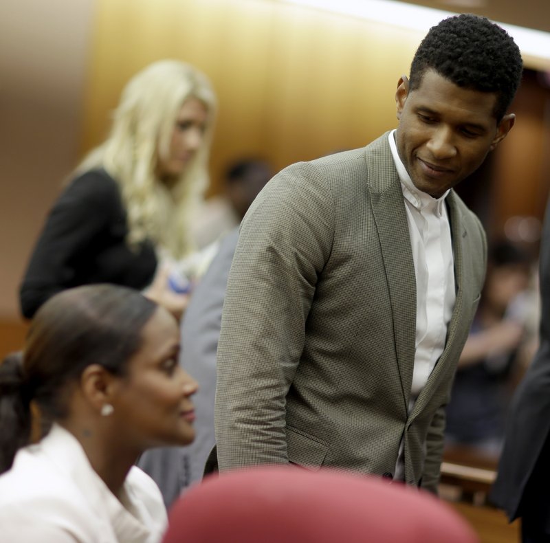 Usher greets ex-wife Tameka Foster Raymond after a hearing Friday in Atlanta. Their son, 5, had been stuck in a pool drain.