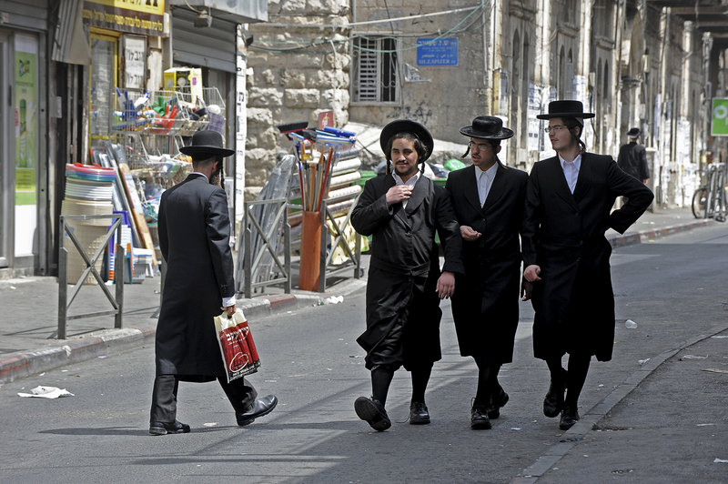 Ultra-Orthodox Jews known as Haredi may soon join their secular counterparts in taking responsibility to defend Israel Shown above are Haredi Jews in the Me’a She’arim neighborhood in Jerusalem and, below, Haredi Jews during religious studies in the Sha’arei Hesed neighborhood in Jerusalem.