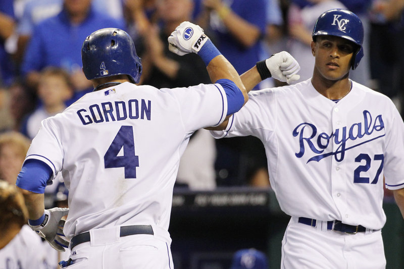 Alex Gordon of the Kansas City Royals is welcomed by Justin Maxwell after hitting a home run in the third inning Friday night of a 9-6 victory against the Boston Red Sox.