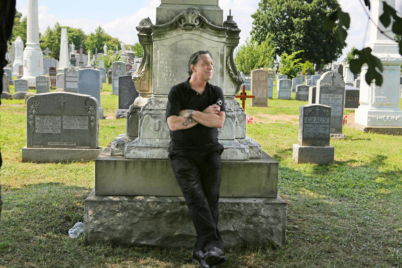 Nick Beef, who was born Patric Abedin, poses among the grave markers at Calvary Cemetery in the Queens borough of New York.