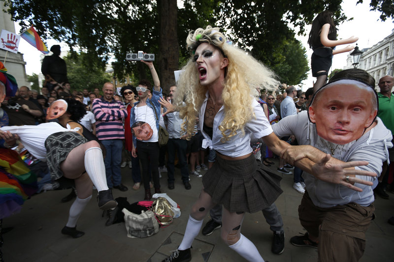 Gay activists stage a play in London where gay people are restrained by others wearing masks depicting Russian President Vladimir Putin during a protest Saturday.