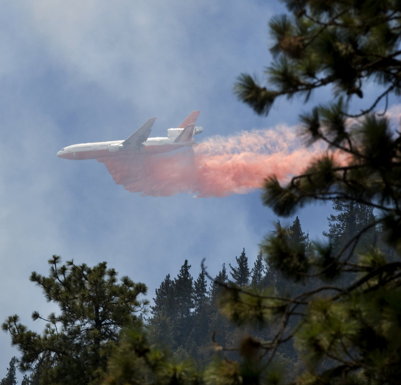 A plane drops retardant on a fire Friday in Wrightwood Calif. So far this year, fire officials have battled 4,300 wildfires in the state.