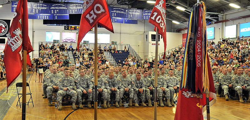 Flags and banners frame the troops during a send-off ceremony Saturday for the 133rd Engineer Battalion and the 1035th Survey and Design Team at the Portland Expo in Portland. The soldiers were chosen for a one-year deployment to Afghanistan.