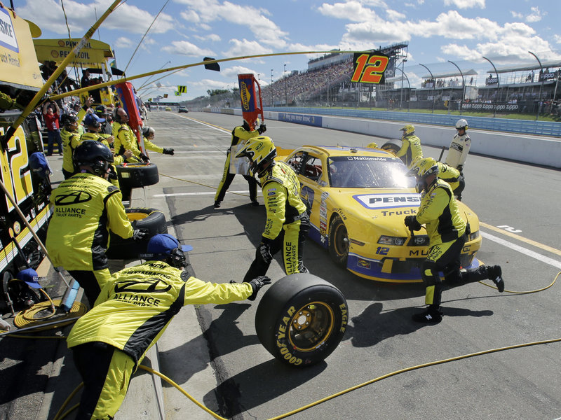 The crew for Sam Hornish Jr. gets busy as he makes a pit stop during the NASCAR Nationwide Series race at Watkins Glen, N.Y., on Saturday. Hornish came in second, losing by 1.4 seconds to reigning Sprint Cup champion Brad Keselowski.