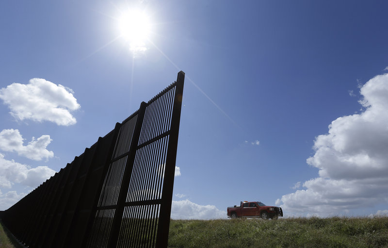 Cotton farmer Teofilo "Junior" Flores drives his truck along the U.S.-Mexico border fence that cuts through his property in Brownsville, Texas. "'Building more fence makes no sense to me."