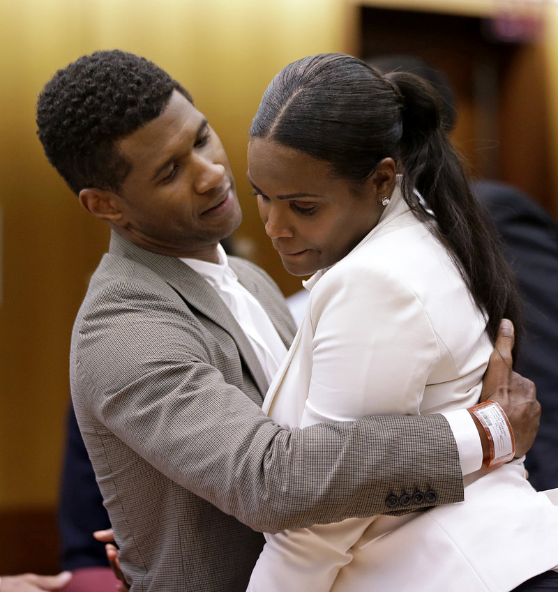 Usher embraces ex-wife Tameka Foster Raymond last week after a judge dismissed her request to have temporary custody of their two children.