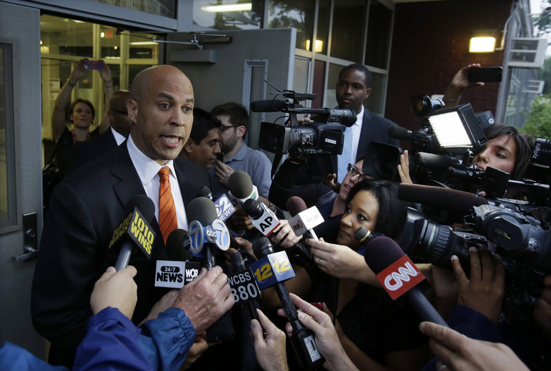 Newark Mayor Cory Booker answers a question after voting Tuesday in Newark, N.J. He won the Democratic primary.