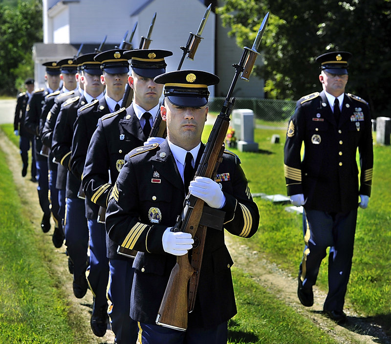 Members of the Maine Military Funeral Honors Program, part of the Maine National Guard, enter the Pleasant Ridge Cemetery in Hiram on Thursday to honor four servicemen from the same family killed in past wars.