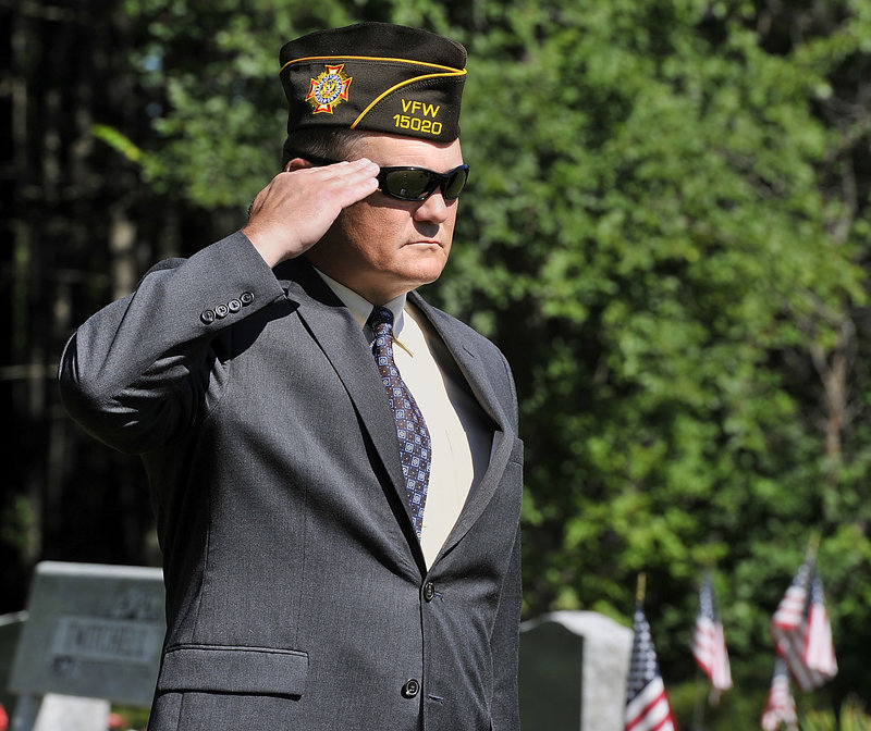 Francis Lyons, Jr. salutes during the playing of Taps for his four relatives, who were killed in past wars.