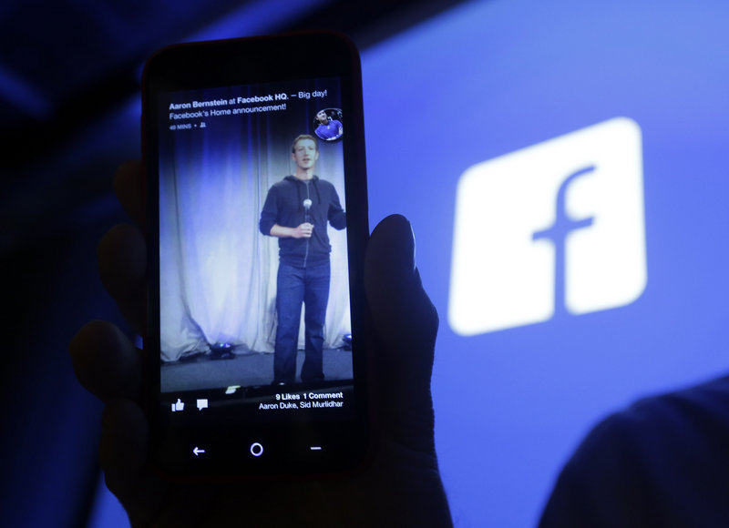 Facebook’s mobile interface is displayed on a cellphone in April. Facebook plans to test a mobile payments service using payment data users have added to their Facebook account.
