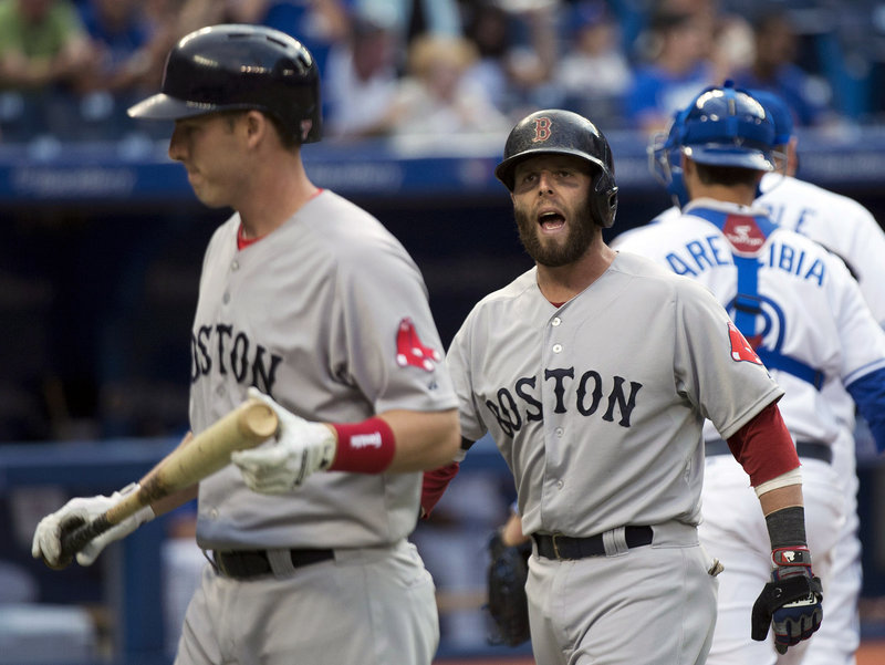 Dustin Pedroia, right, isn’t happy with teammate Stephen Drew following a play at the plate Thursday night during Boston’s 2-1 loss to the Toronto Blue Jays.