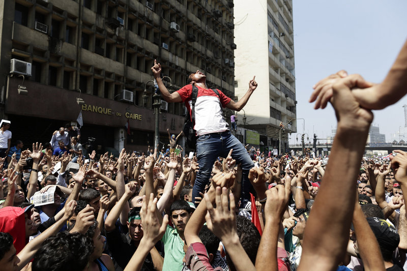 Supporters of ousted President Mohammed Morsi, above, chant slogans against Defense Minister Gen. Abdel-Fattah el-Sissi before clashing with Egyptian security forces in Ramses Square, in downtown Cairo, on Friday.