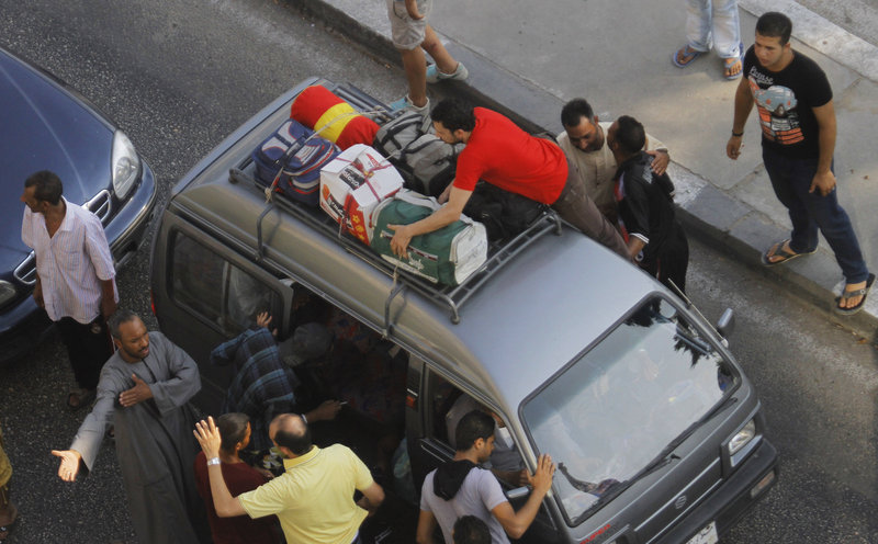 Egyptian volunteers search for militants at a makeshift checkpoint on Cornich El-Nile street in Cairo.