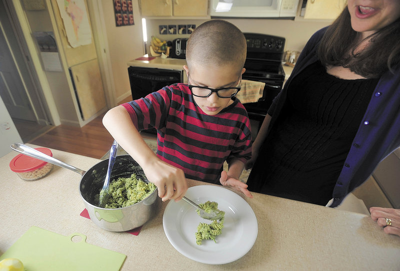 Noah Koch, 9, of Waterville, prepares his award winning pesto at his Waterville home on Friday. Noah was selected as a winner in First Lady Michelle Obama’s Healthy Lunchtime Challenge, an honor that brought the local boy to Washington to meet the First Lady and President Obama.