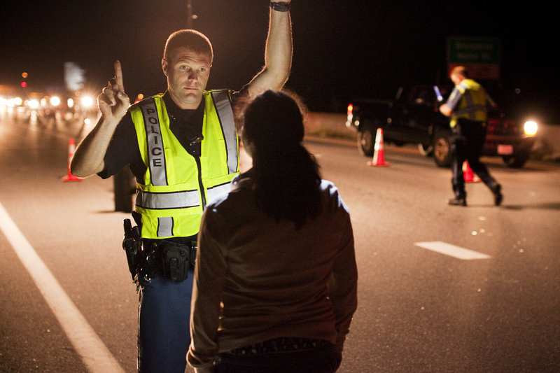 Cumberland Police Officer Ryan Martin, below, conducts a field sobriety test Friday.