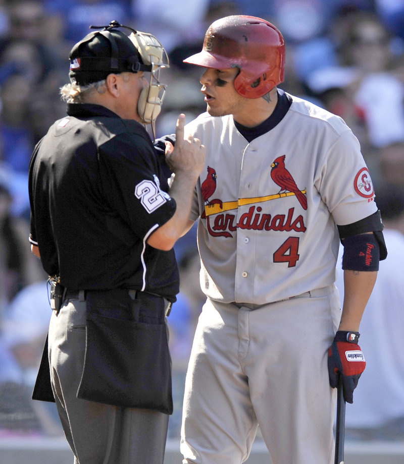 Yadier Molina of the St. Louis Cardinals argues with umpire Tom Hilton after striking out during a 4-0 win over the Cubs at Chicago on Saturday.