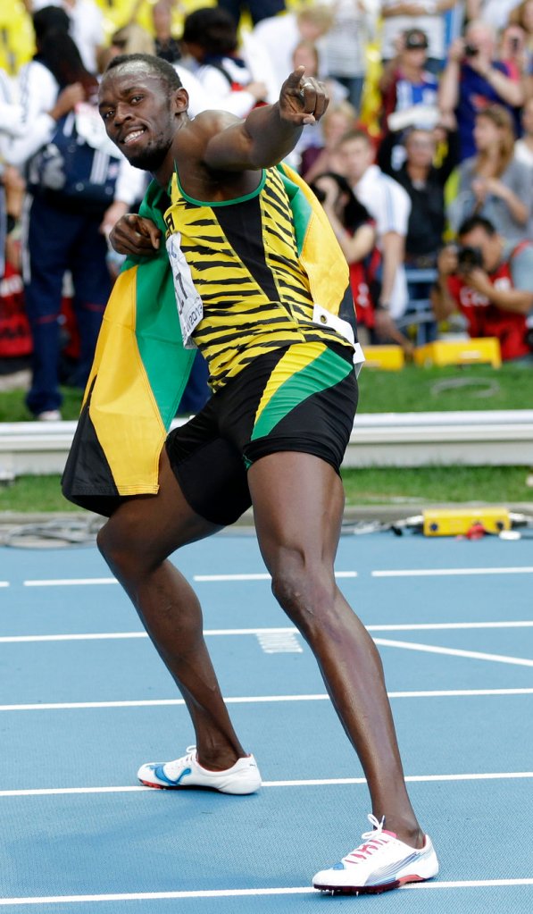 Usain Bolt of Jamaica strikes his classic pose after winning the 200 meters at the world track and field championships in Moscow on Saturday.