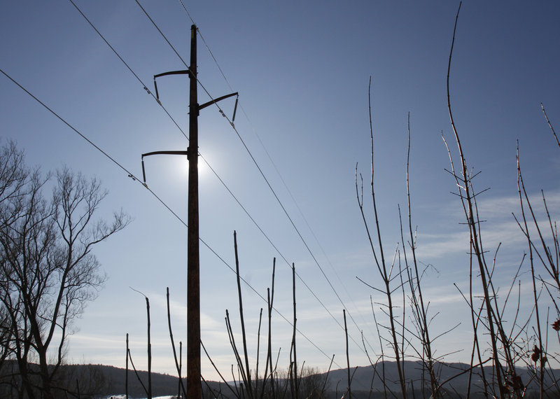 Power lines run through Duxbury, Vt. Vermont’s largest utility has been cheering the arrival of solar energy and “net metering,” while smaller utilities have been pushing back.