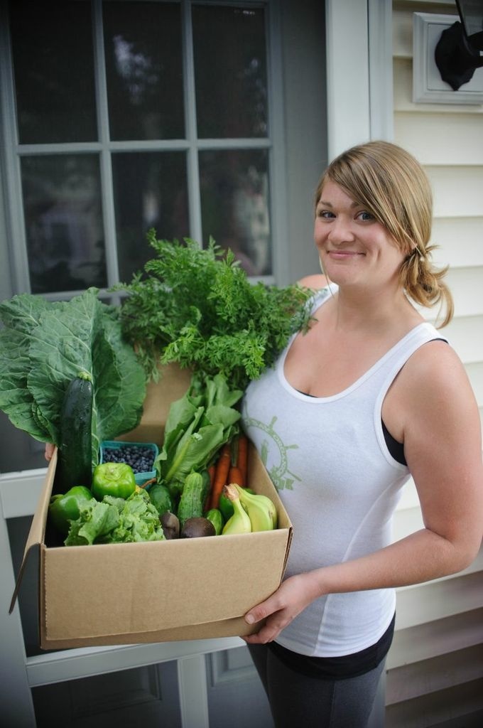 Casco Bay Organics owner Jillian Hilton delivers a small box of fresh produce to a home in Portland.