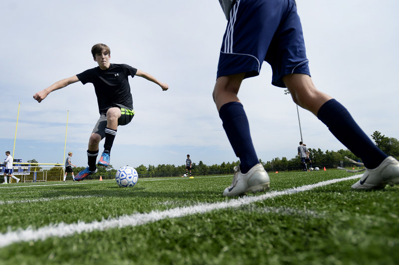 Falmouth boys’ soccer player Nick Buckley works on a dribbling move as he tries to maneuver past a teammate during the team’s first practice.