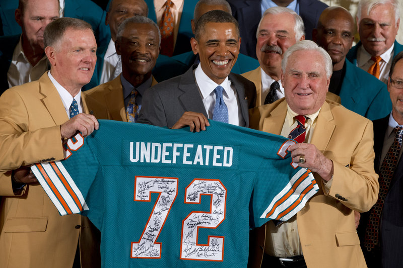 Former Dolphins quarterback Bob Griese, left, holds a signed jersey with President Barack Obama and former coach Don Shula during a White House ceremony Tuesday.