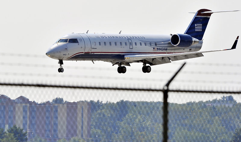 A US Airways Express prepares to land at the Portland International Jetport last week. US Airways and four other airlines – United, Delta, JetBlue and Southwest – fly out of Portland to 12 nonstop destinations.