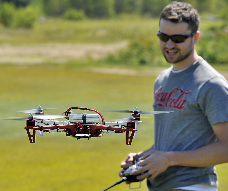 Adam Courtemanche of Portland tests his F450 Quadcopter before attaching a GoPro camera to search for a member’s missing plane.