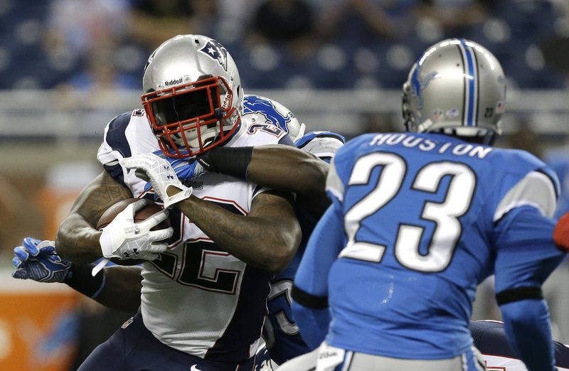 New England Patriots running back Stevan Ridley (22) is wrapped by the Detroit Lions defense in the first quarter in Detroit on Thursday.