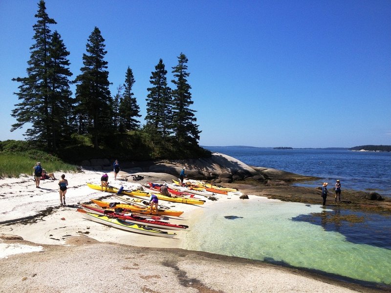 Paddlers enjoy an island visit on the Maine Island Trail off Stonington. The 375-mile recreation water trail, which connects islands and mainland sites from Kittery to the Canadian border, is celebrating its 25th anniversary.