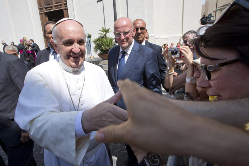 Pope Francis greets the faithful Aug. 15 as he leaves Castel Gandolfo, the pontiff’s summer residence in the hills overlooking Rome. Francis has charmed the masses with his informal style, simplicity, sense of humor – and some personal calls.