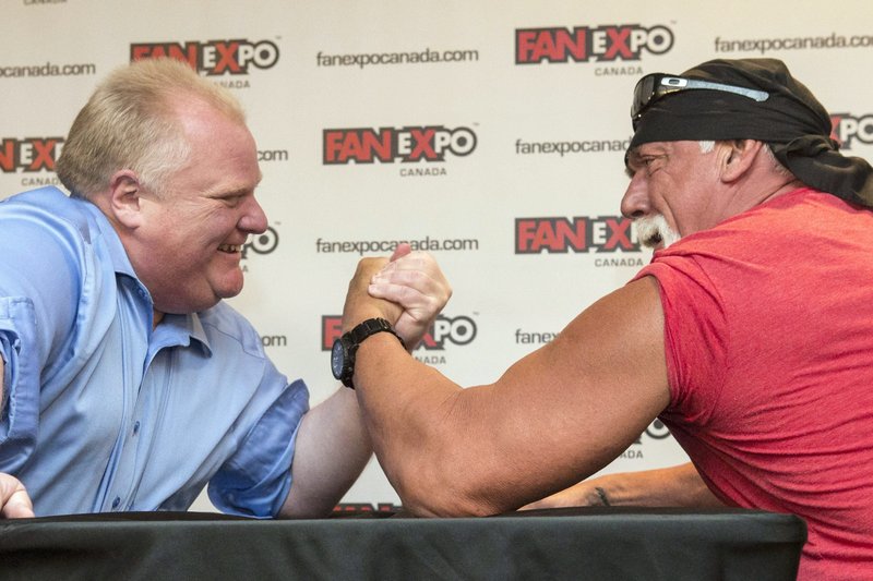 Toronto Mayor Rob Ford, left, takes on Hulk Hogan in an arm-wrestling match to promote Fan Expo in Toronto on Friday.