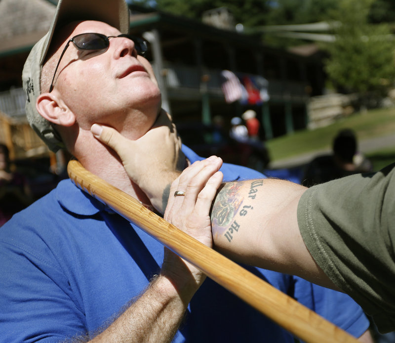 Volunteer Shawn Withers, left, advises Marines veteran David Marino, a Medford native who lives in Burbank, Calif., on a self-defense technique using a cane Saturday at Camp Wavus on Damariscotta Lake in Jefferson.