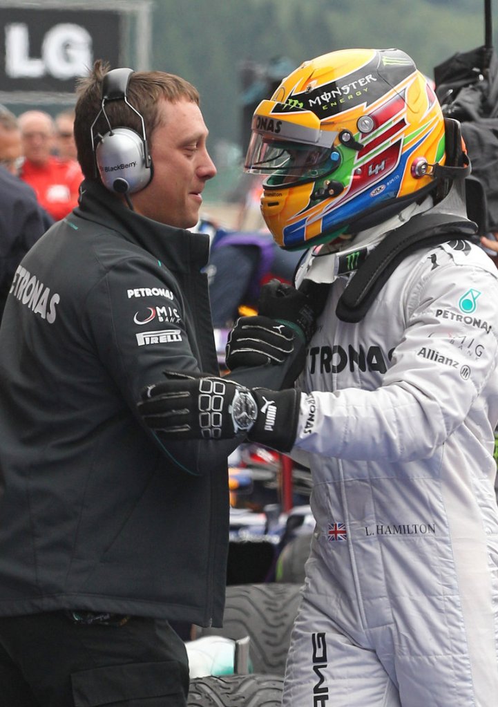 Lewis Hamilton is greeted by his team technician after winning his fourth straight Formula One pole at the Belgian Grand Prix.