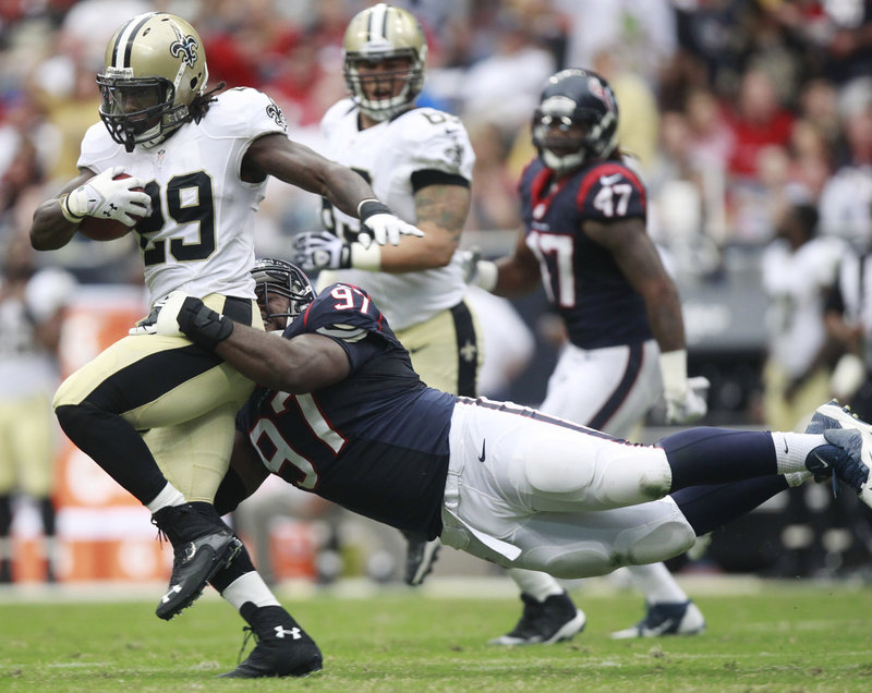 Saints running back Khiry Robinson tries to break away from Houston’s Terrell McClain during Sunday’s preseason game in Houston. New Orleans won, 31-23.