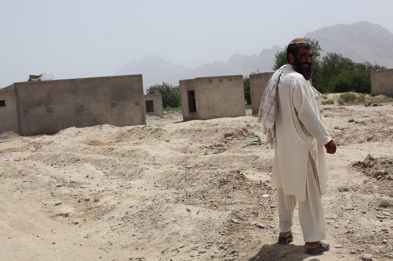 Niaz Mohammad stands on the land that was covered by Tarok Kolache’s houses before Americans bombed the village in 2010. Less than half of the village was rebuilt after the bombardment.