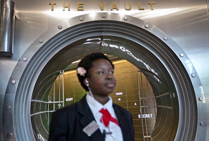 Security officer Marilyn Buamah guards the soda “secret recipe” vault while waiting for a tour group at the World of Coca-Cola museum in Atlanta. The vault is bathed in red security lights and monitored by cameras.