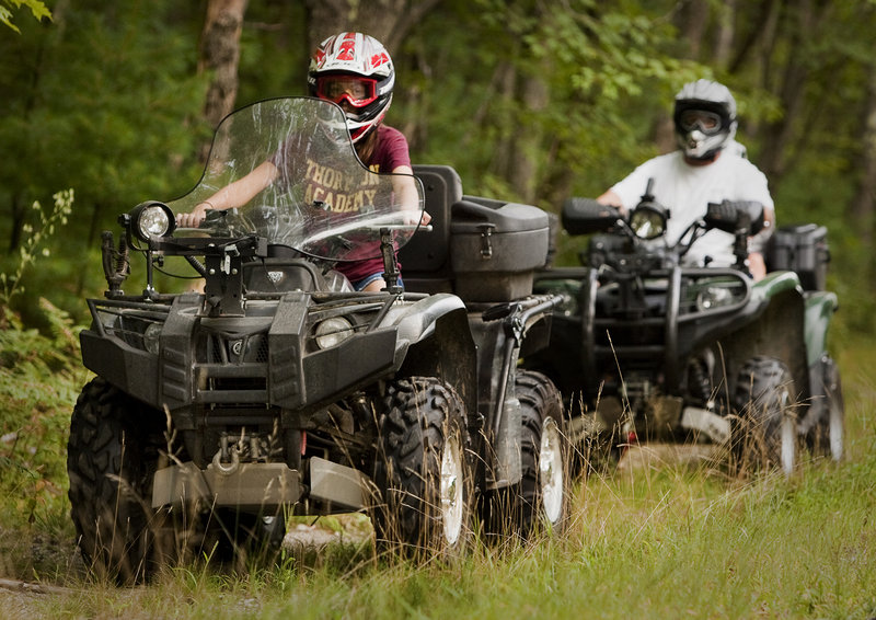Twelve-year-old Alyssa Lajoie leads the way during a ATV trail ride with her Dad, Jim Lajoie, and his passenger, brother Ian, age 8, near their Dayton home on Monday, August 26, 2013. Alyssa took the training class at age 10 with her mother and was certified to ride on public trails.