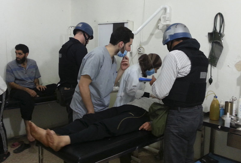 U.N. chemical weapons experts visit victims of an apparent gas attack at a hospital near Damascus on Monday. “This is the effect of chemicals,” said a man who appeared to be a doctor.