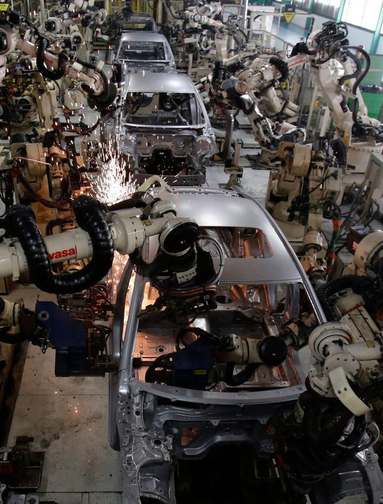 Robots work Tuesday on the Mazda6 car model assembly line at Mazda Motor Corp.’s plant in Hofu, Yamaguchi prefecture, in southwestern Japan.