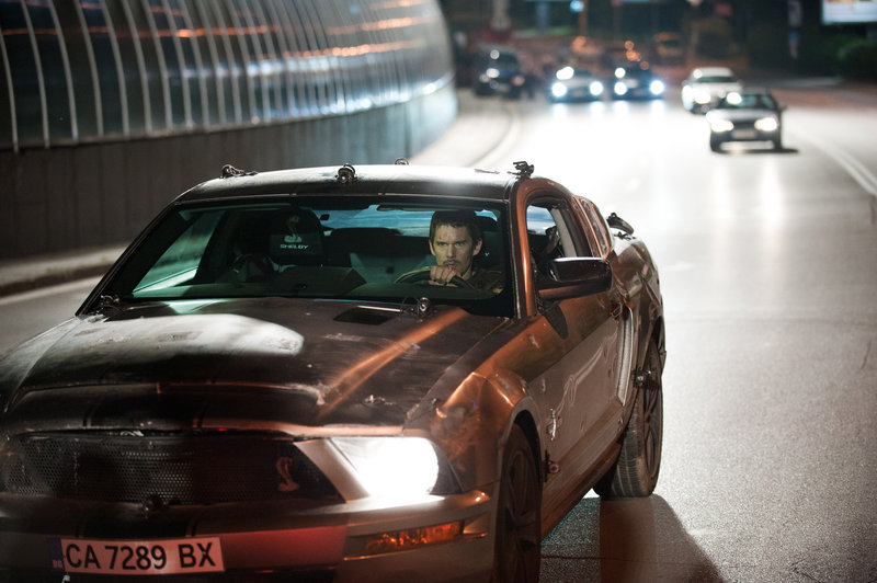 Ethan Hawke stars as a disgraced racecar driver trying to save his wife (Rebecca Budig) from kidnappers in “Getaway.”