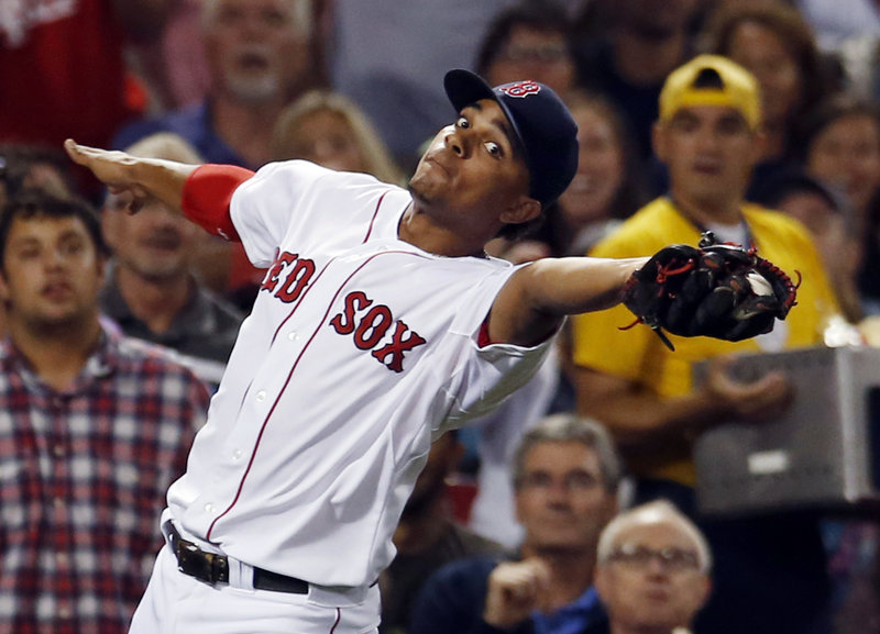 Xander Bogaerts, third baseman for the Red Sox, catches a foul pop by Baltimore’s Nate McLouth in the third inning Wednesday night at Fenway Park. The Red Sox rallied for a 4-3 victory.