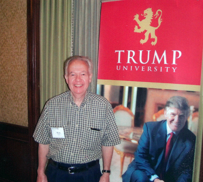 Bob Guillo poses with a cardboard cutout of billionaire Donald Trump in New York. Guillo paid $35,000 to attend a Trump University seminar but never got to meet Trump in person.