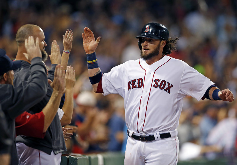 Jarrod Saltalamacchia receives high-fives after scoring the winning run against the Orioles on Mike Carp’s pinch-hit single in the eighth inning Wednesday night at Fenway Park.