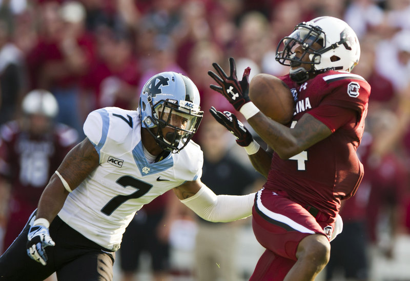 South Carolina wide receiver Shaq Roland catches a touchdown pass against North Carolina’s Tim Scott during the Gamecocks’ 27-10 win on Thursday in Columbia, S.C.