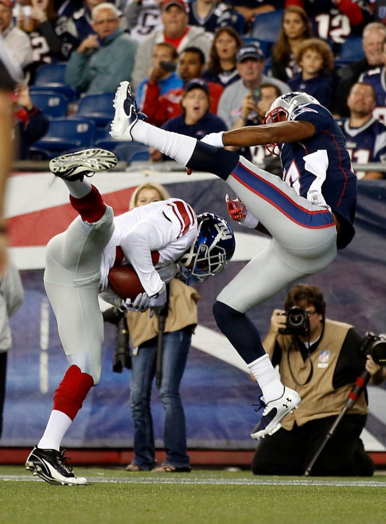 New York cornerback Prince Amukamara, left, intercepts a pass intended for New England wide receiver Aaron Dobson during second-quarter action Thursday.
