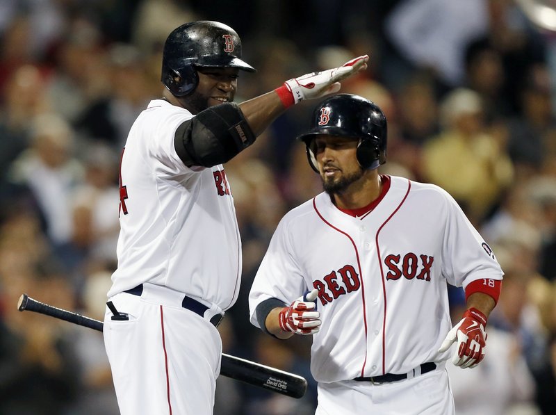 Boston’s Shane Victorino gets a pat on the helmet from David Ortiz after Victorino’s solo homer in the sixth inning of a 3-2 loss to the Orioles at Fenway Park on Thursday.