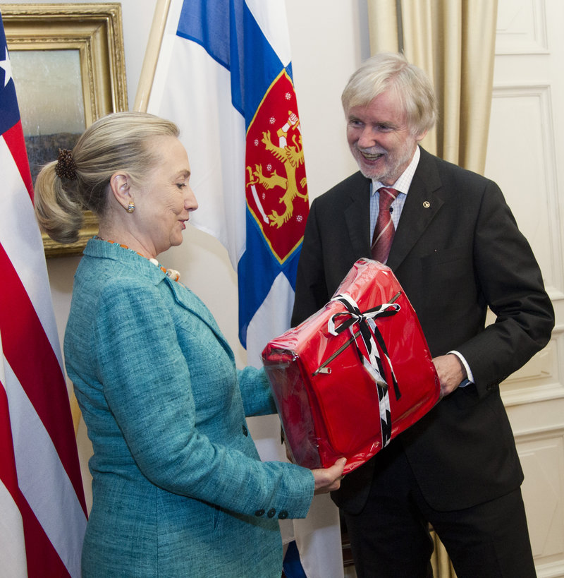 Secretary of State Hillary Rodham Clinton receives a gift from Finnish Foreign Minister Erkki Tuomioja at the Government Banquet Hall in Helsinki in 2012.