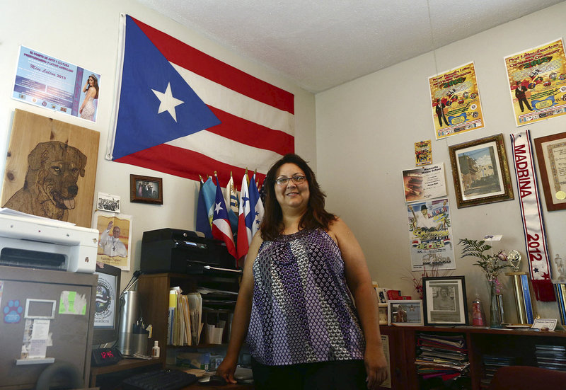 Mariangeli Vargas, founder of the recently-formed Puerto Rican and Latin American Art and Culture Committee, stands in the office at her New Bedford, Mass., home, in June.