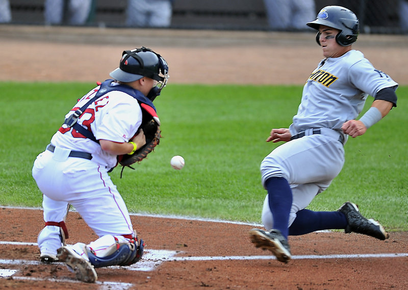 Portland catcher Christian Vazquez can’t handle the throw as Trenton’s Tyler Austin slides home during an 8-0 win by the Thunder at Hadlock Field on Saturday.