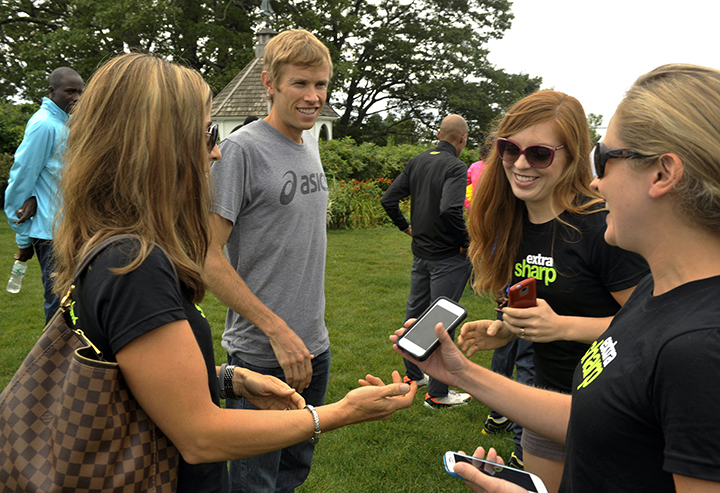 A group of young women, including Anne Mauney, right, ask to have their photos taken with American runner Ryan Hall following the Beach to Beacon 10K news conference at Inn by the Sea in Cape Elizabeth on Friday.
